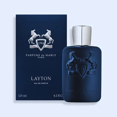 A product shot of a perfume bottle and its box, presented on a light gray background.