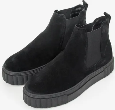 A pair of black Chelsea boots with thick soles are shown against a white background.