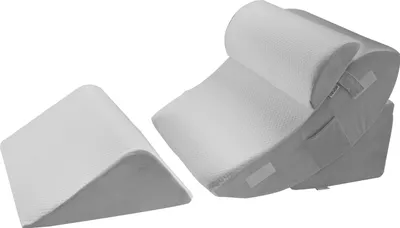 Two orthopedic wedge pillows are shown against a white background. One is a single wedge, and the other is a stacked set of two wedge pillows, one on top of the other, with a curved top pillow.