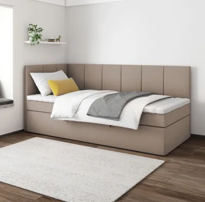 A bedroom setting with a bed and a rug.