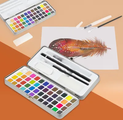 A watercolor paint set with 48 colors, brushes, and other accessories laid out on a light orange and white background, with a painted feather in the midground.
