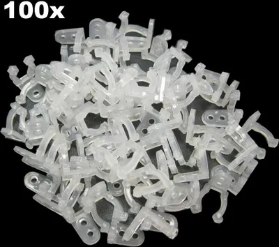 A pile of clear plastic cable clips on a black background.