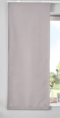 A gray panel curtain hangs in front of a window.