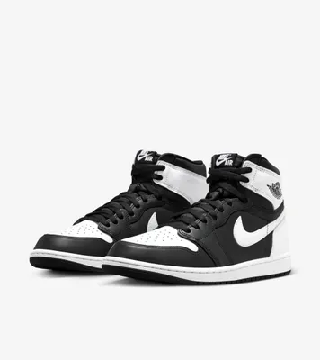 A pair of black and white Nike Air Jordan 1 Mid Retro sneakers are shown against a plain white background.