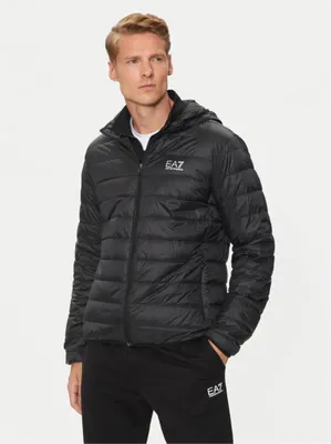 A man wearing a black puffer jacket and black sweatpants.