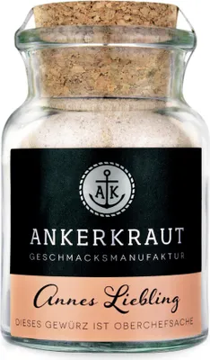 A glass jar of seasoning with a cork lid.
