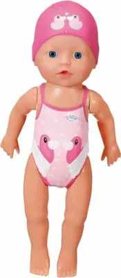 A baby doll wearing a pink swimsuit and swim cap.