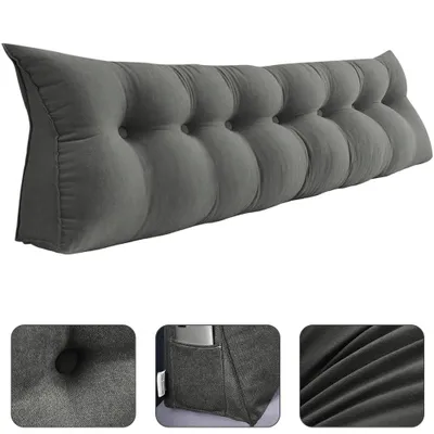 A long, gray, tufted wedge pillow designed to be placed behind a person on a bed or sofa.