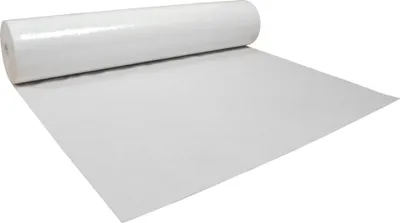 A roll of white protective fleece is unrolled on a white surface.