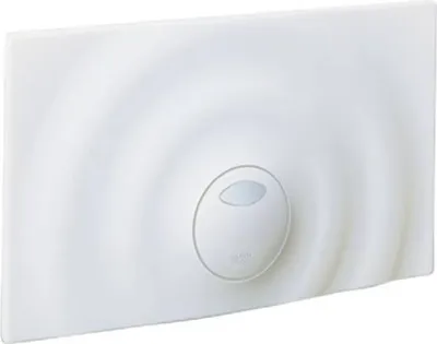 A white toilet flush plate with a circular ripple pattern and a central oval button.