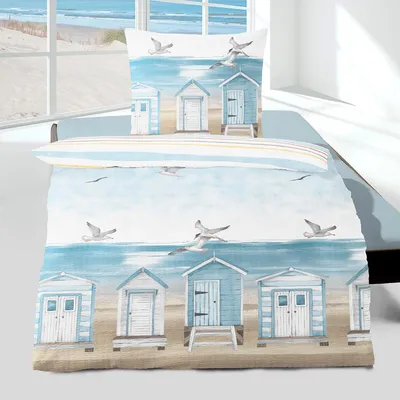 A beach-themed duvet cover and pillowcase set displayed on a bed, with a window view of a beach in the background.