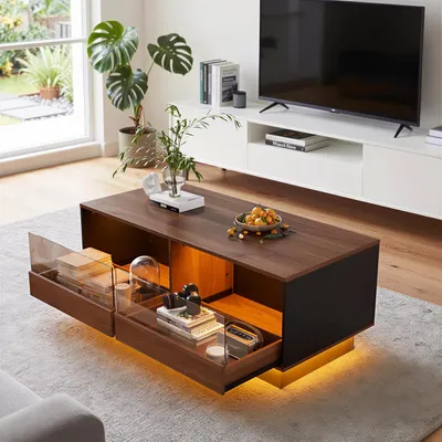 A modern living room with a coffee table in the foreground and a TV stand and TV in the background.