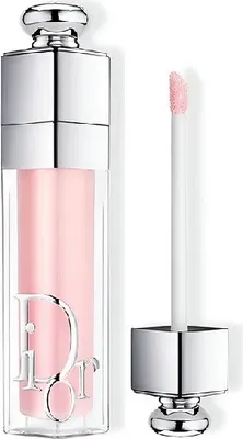 A Dior Addict Lip Maximizer in a light pink shade, with its applicator wand shown separately.