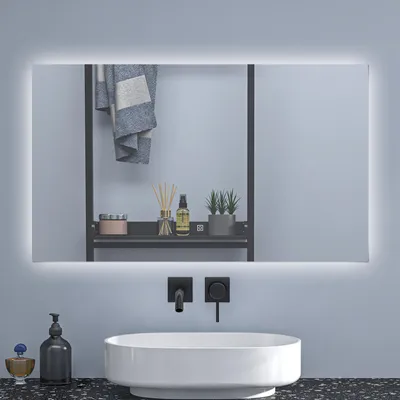 A modern bathroom vanity with a sink, faucet, and a lighted mirror.