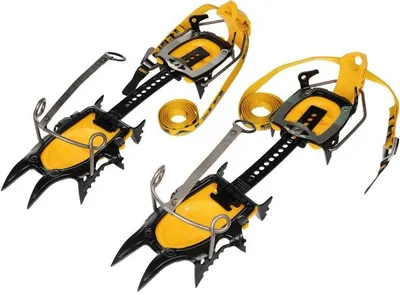 Two pairs of yellow and black climbing crampons are displayed against a white background.