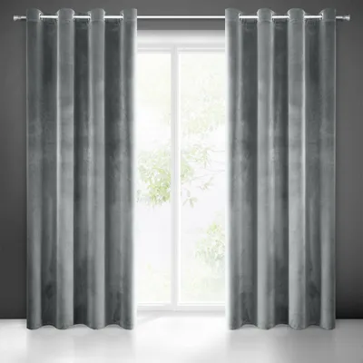 A pair of gray velvet curtains hanging in front of a window.