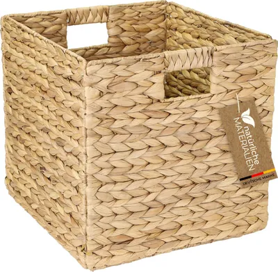 A woven storage basket made of water hyacinth, with handles and a tag attached.