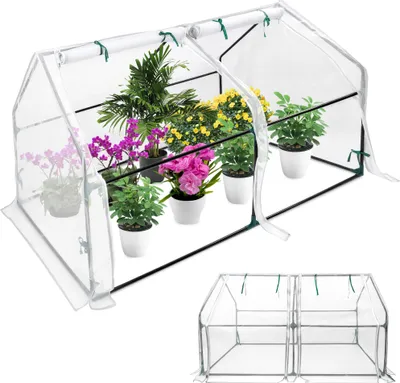 A small greenhouse filled with potted plants.