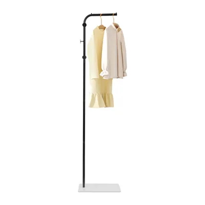 A freestanding coat rack with two garments hanging on it, set against a white background.