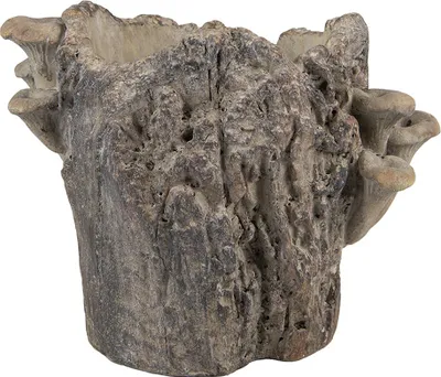 A close-up studio shot of a decorative planter shaped like a tree stump with mushrooms growing on its side.