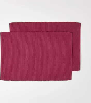 Two red placemats are arranged on a white background.
