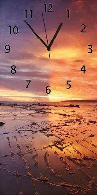 Produktbild von Wallario Design Wanduhr Wattwanderung am Meer bei Sonnenuntergang aus Echtglas, Größe 30 x 60 cm
