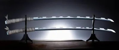 Two swords are displayed on a stand against a dark, spotlighted background.