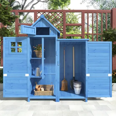 A blue wooden garden shed with tools and gardening supplies inside, set on a patio.