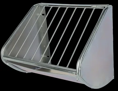 A metal hay feeder for animals, mounted on a black background.
