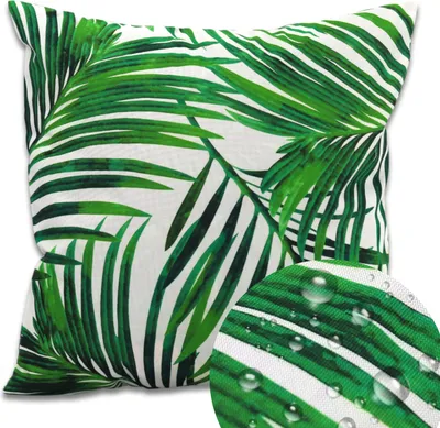 A square cushion with a green palm leaf pattern on a white background.