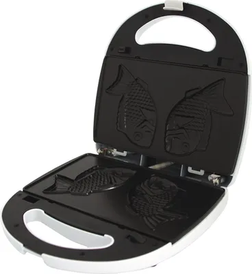 An open waffle maker with fish-shaped molds.
