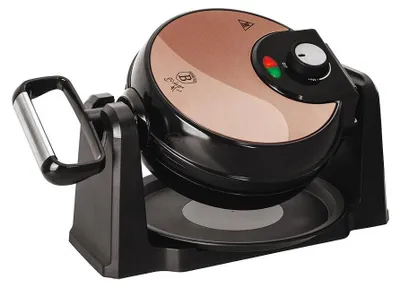 A rose gold and black waffle maker is shown against a white background.