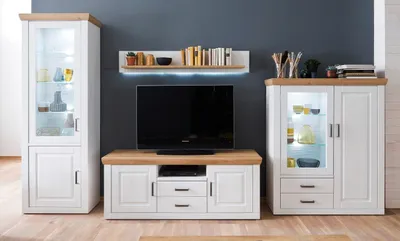 A living room setting with a TV stand, two display cabinets, and a shelf.