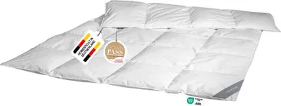 A white down comforter is laid out on a white background, with tags attached.