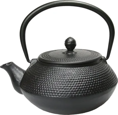 A black cast iron teapot with a textured surface and a curved handle, presented on a white background.