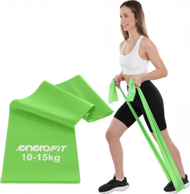 A woman is using a green Pilates resistance band for exercise. A folded green resistance band is shown in the foreground.