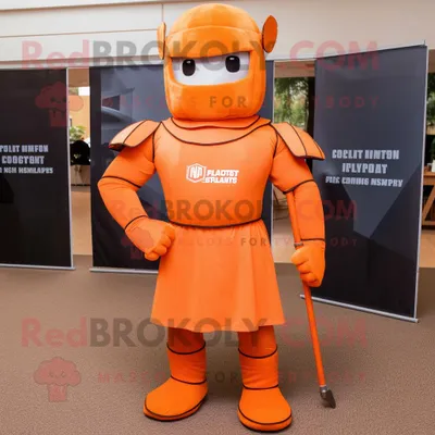 Immagine prodotto di Personaggio del costume della mascotte REDBROKOLY del soldato spartano arancione vestito con una maglietta da polo e fermacravatta