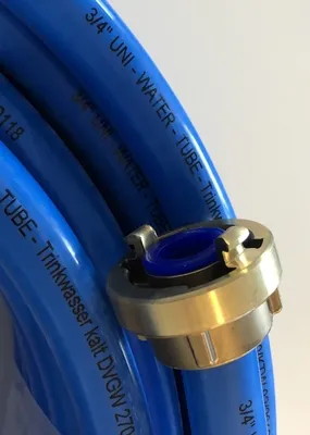 A close-up view of a blue water hose with a metal coupling attached.