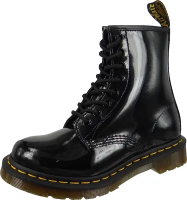 A black patent leather Dr. Martens boot is shown against a white background.