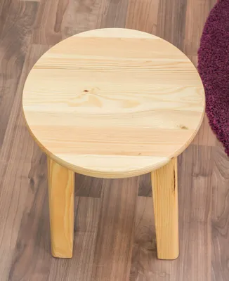 A round wooden stool on a wooden floor.