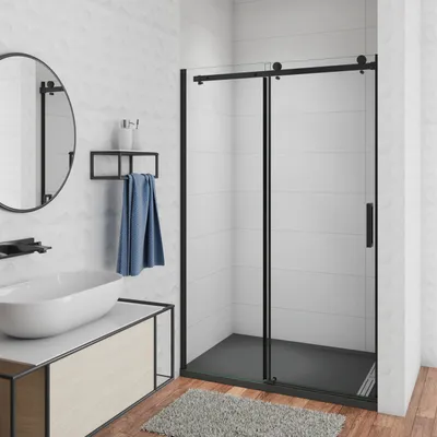 A modern bathroom with a shower cabin, sink, and vanity.