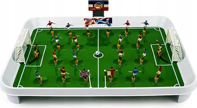 A tabletop foosball game with miniature players on rods, set up on a green field with goals.