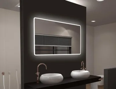 A modern bathroom vanity with a large LED mirror and two sinks.