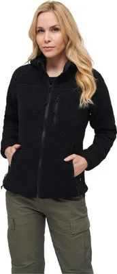 A woman wearing a black fleece jacket and green cargo pants, posing against a white background.