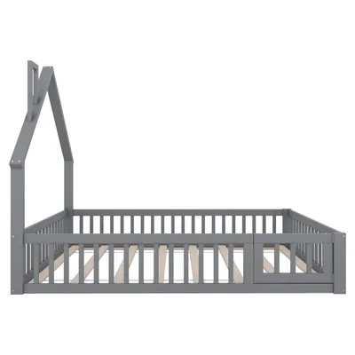 A grey house-shaped bed frame with a slatted base and a partial railing, shown from the side against a white background.
