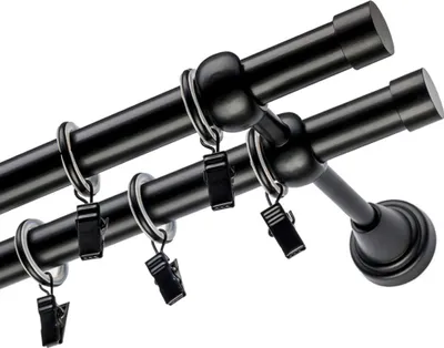 A close-up, angled view of a double curtain rod with rings and clips.