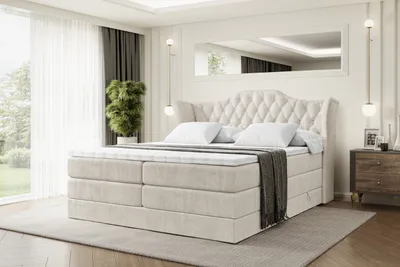 A luxurious bedroom with a large tufted bed.