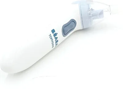 A white electric baby nasal aspirator with blue accents lies on a white surface.