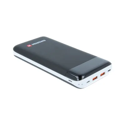 A black power bank with white trim and orange USB ports is shown against a white background.