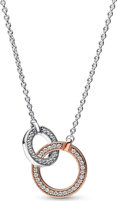 A close-up studio shot of a necklace with two interlocking rings.